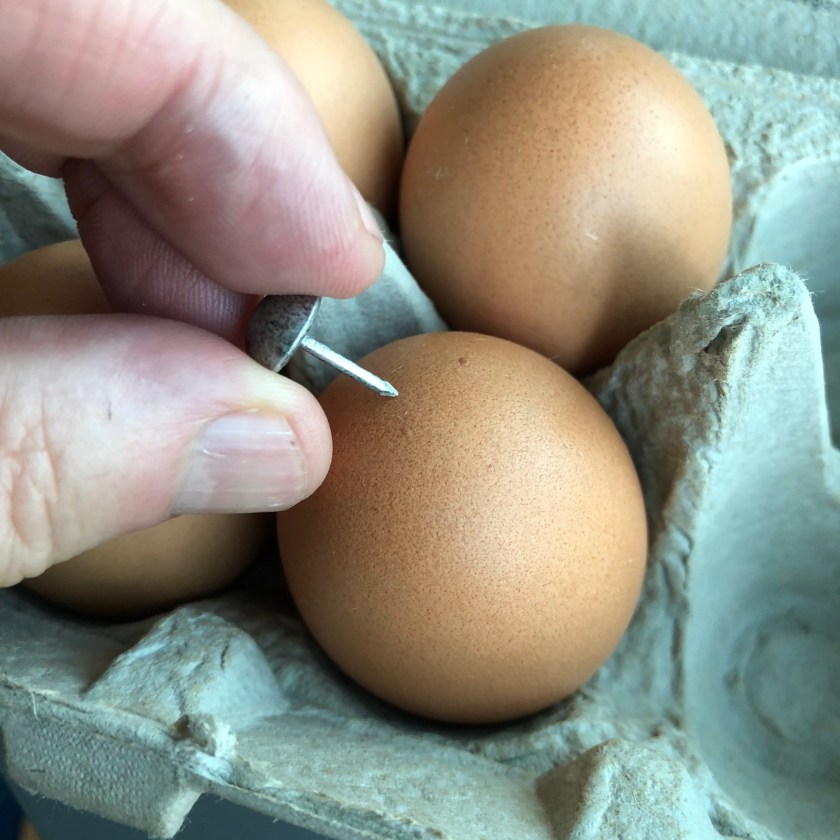 Prick the top of each egg.