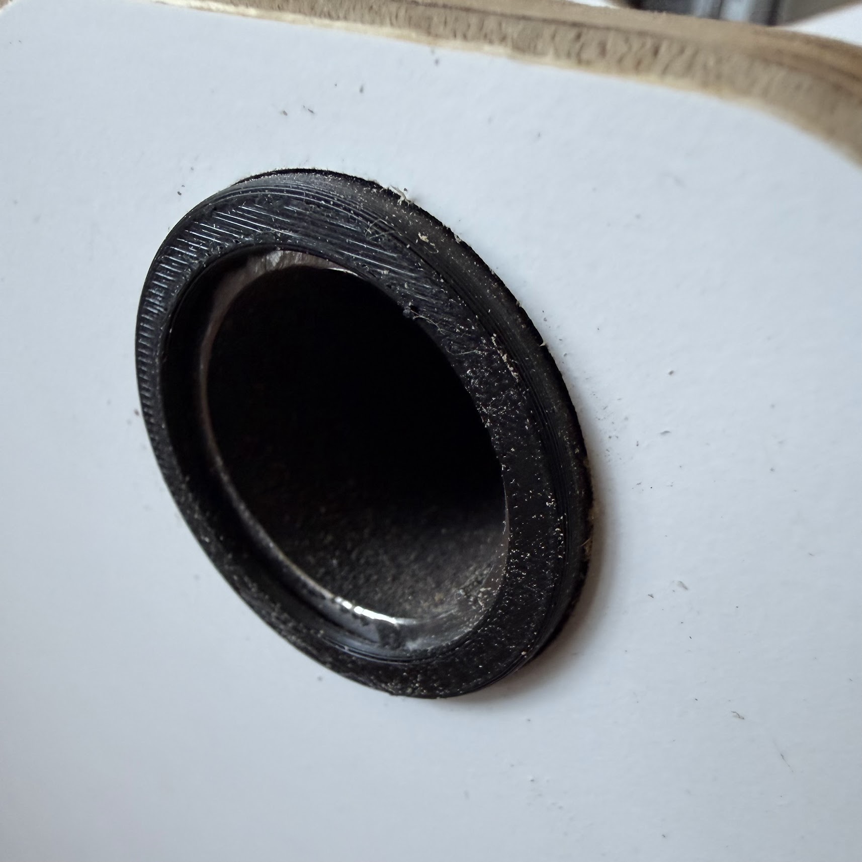 Pipe passing through the grommet, viewed from outside the box.