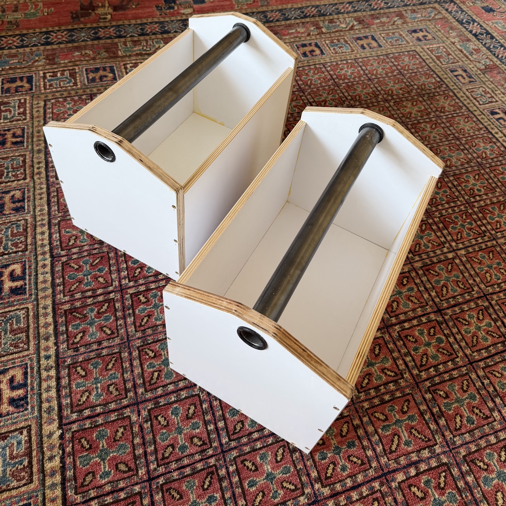 Two glued and screwed plywood boxes sitting next to a bag of high strength concrete mix.